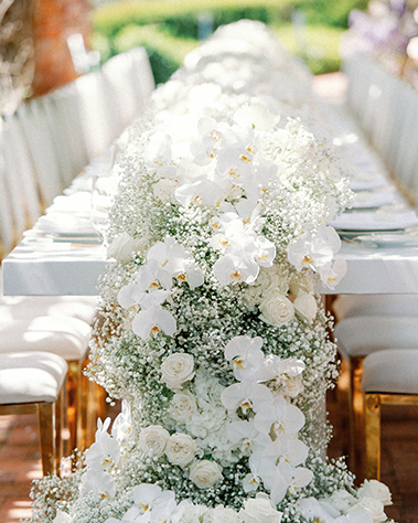 White flowers used as a centerpiece at an outdoor wedding