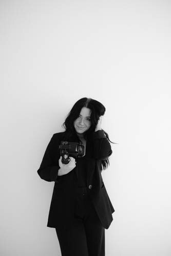 black and white image woman holding camera