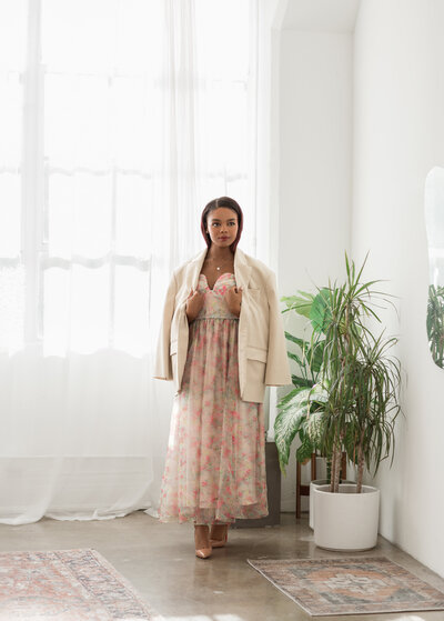 Tahirah smiling big holding a copy of magazine "the knot"