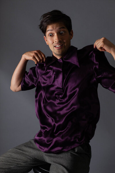 JWR model wearing purple silk shirt with funny face