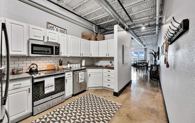 Kitchen with stainless steel appliances in this studio vacation rental condo in the historic Behrens building with a 5th floor view of downtown Waco, TX