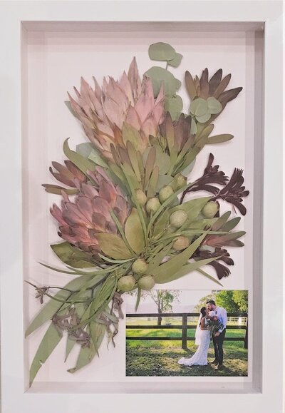 Pressed flowers meticulously arranged in a custom frame, preserving their beauty for a lifetime.