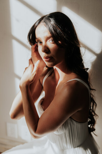 Bride in sunbeams looking at camera