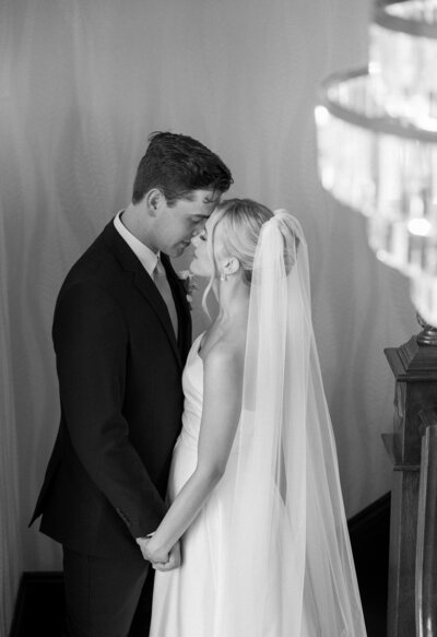 A classic black and white portrait of a bride and groom on the staircase at Venue 3 Two in Grand Rapids, Michigan.