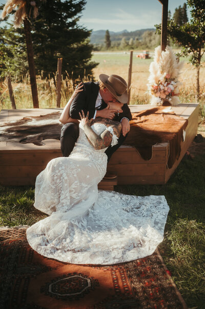 Wedding in the forest, western decor groom dipping bride and kissing her