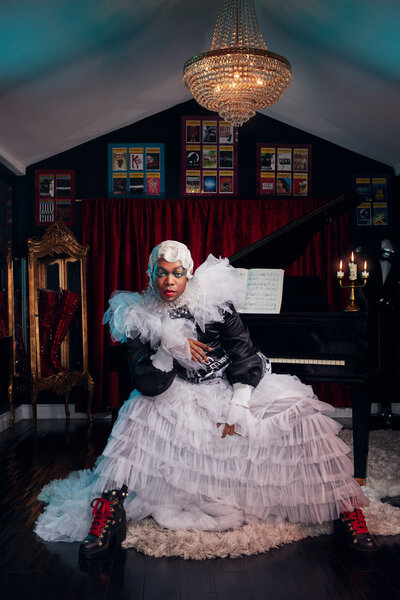 Vibrant portrait of Todrick Hall in an eclectic outfit, posing in a lively club setting, captured by Ylva Erevall.