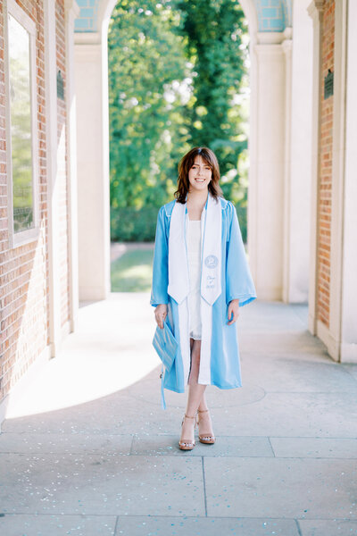 A student posing at UNC's Bell tower
