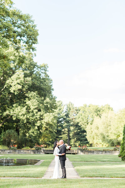 Bride and groom kissing on their wedding day at Stan Hywet photographed by akron ohio wedding photographer