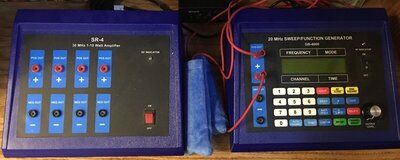 A Rife machine setup featuring a frequency generator and amplifier with multiple ports, cables, and a numeric control panel for customized healing frequencies.