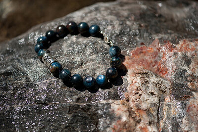 Blue Kyanite Bracelet laying in the sun on a rock.