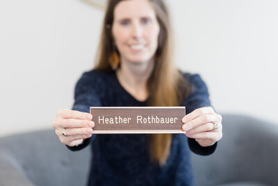 Metal name plate with words "Heather Rothbauer"