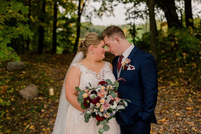 Bride and groom photos in fall at rustic barn wedding venue