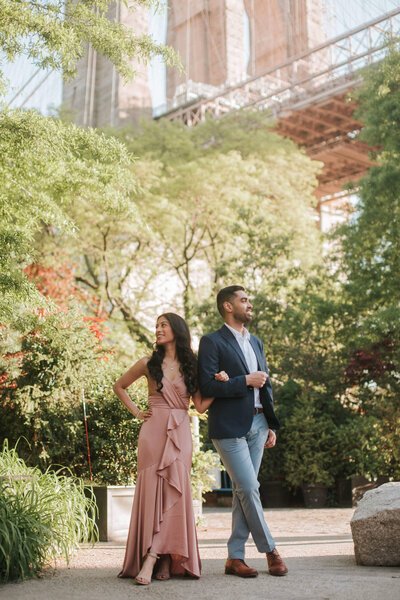 Couple stands side by side in Brooklyn New York during an engagement session.