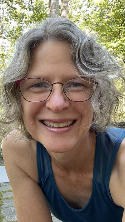 Karen, knee-friendly yoga instructor, smiling at you.