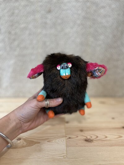 Natalie holding handcrafted fabric sculpture
