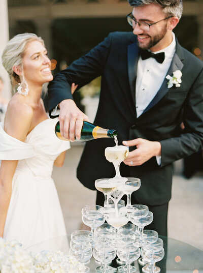 bride and groom pour champagne after their wedding at Castle and Key Distillery in Lexington Kentucky photographed by Lexington Kentucky wedding photographer Magnolia Tree Photo Company