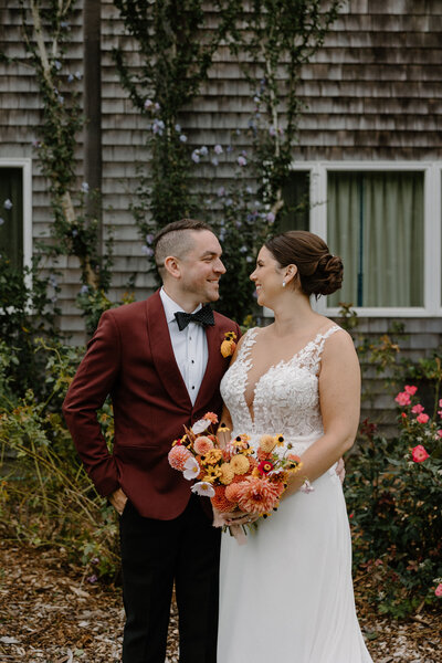 bride and groom smiling at each other