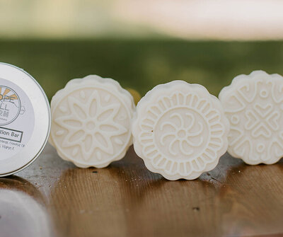 round goat milk lotion bar for dry and sensitive skin on a table