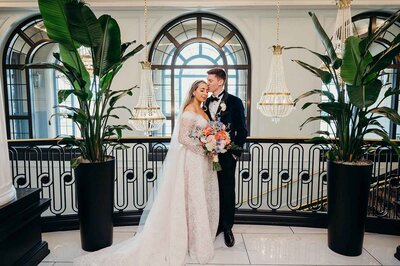 luxury wedding couple posing inside Hotel Carmichael Carmel Indiana