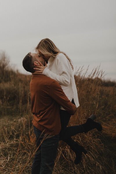 Young couple kissing during engagement photo session in La Crosse, Wisconsin