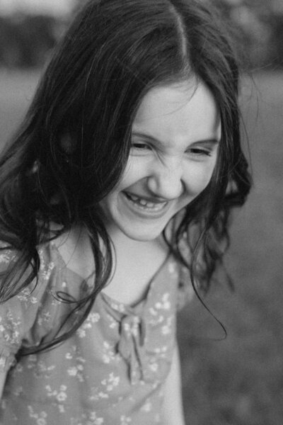 Black and white photo of kid laughing