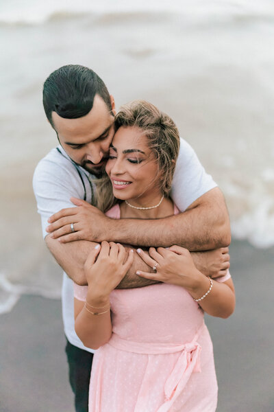 Couple holding each other during engagement shoot