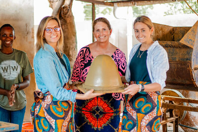 Three women holding up a new clay filter