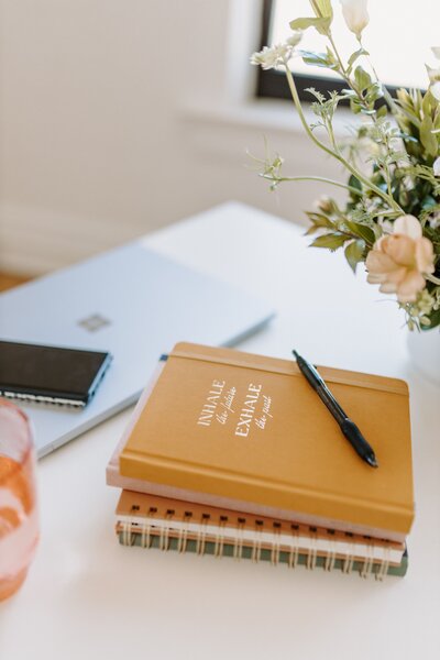 Desk with notebooks and florals