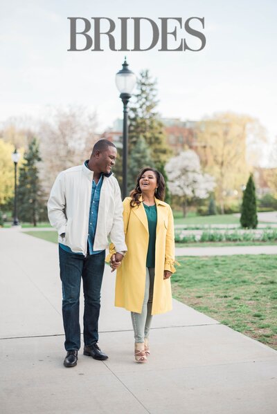 A man and woman hold hands in the park on a Spring day