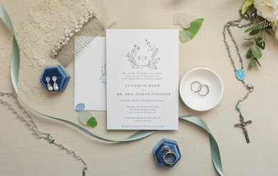 flat lay with blue and neutral wedding details