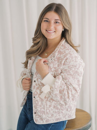 Lexy smiling in a cream and tan blazer