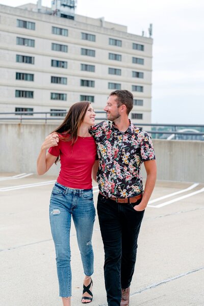 Couple sharing a tender moment on the rooftop during their engagement photo session.