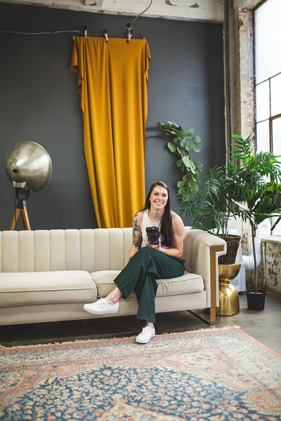 one of the top baltimore photographers, Nicole Simensky, sitting on a couch