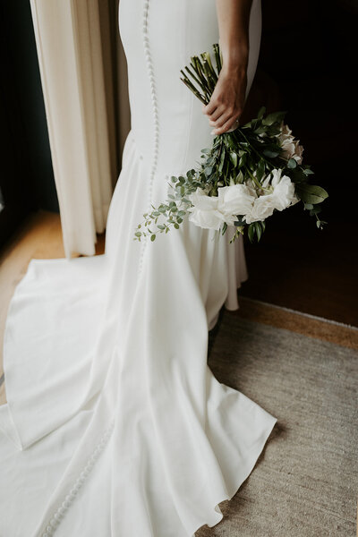 bridal satin gown and bouquet