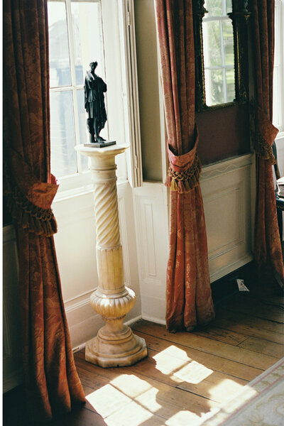 The sun is shining through the window at William Aiken House in Charleston SC