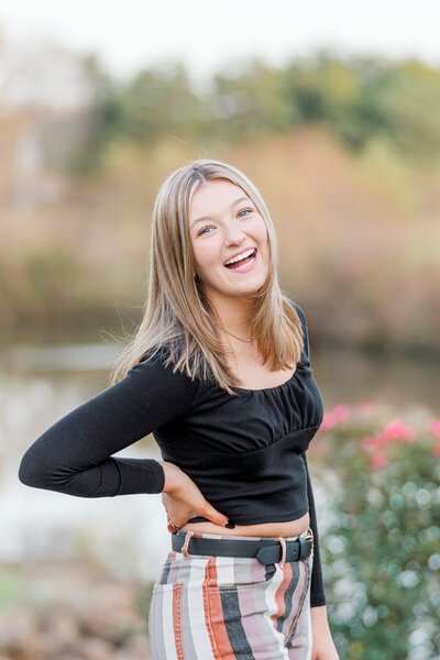 girl laughing with hands on waist during Gainesville, Virginia senior pictures