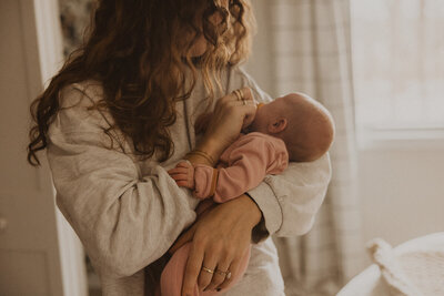 New mother looks down at her newborn baby lovingly