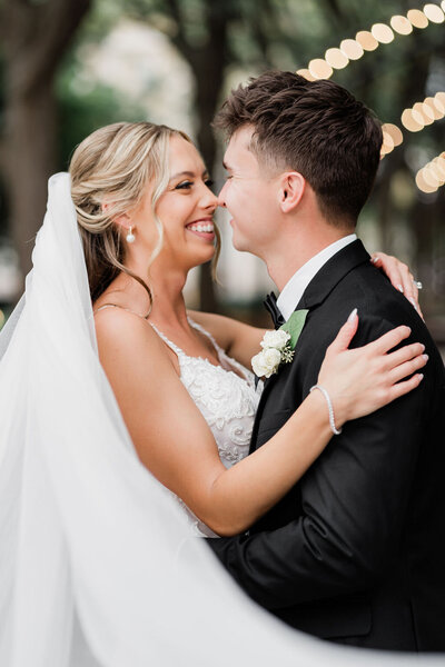 bride and groom holding one another smiling