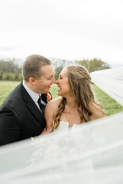 Bride and groom with long veil wedding photo