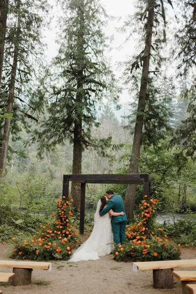 bride and groom holding hands while their bridal party is standing around them