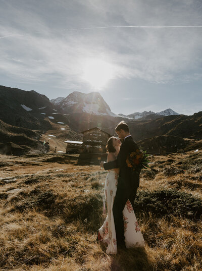 bride and groom looking at each other on top of mountain