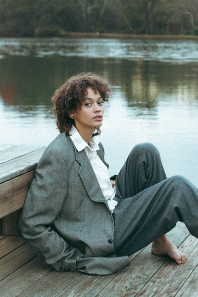 woman sitting by water