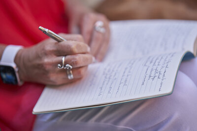 Woman journaling, symbolizing self-reflection, subconscious work, and personal transformation