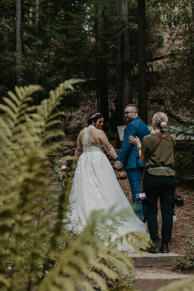photographer coaching bride and groom