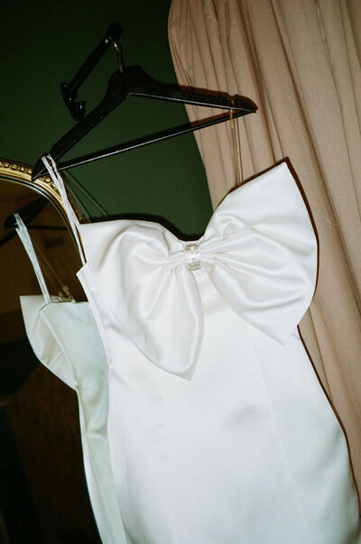 black and white image bride wearing strapless satin wedding dress with long train
