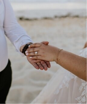 couple holds hands during their destination wedding ceremony