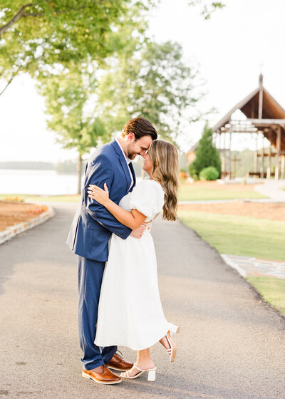 Romantic portrait of Julianna and Josh near a chapel, showcasing timeless love by Abby Bell Photography in Alabama.
