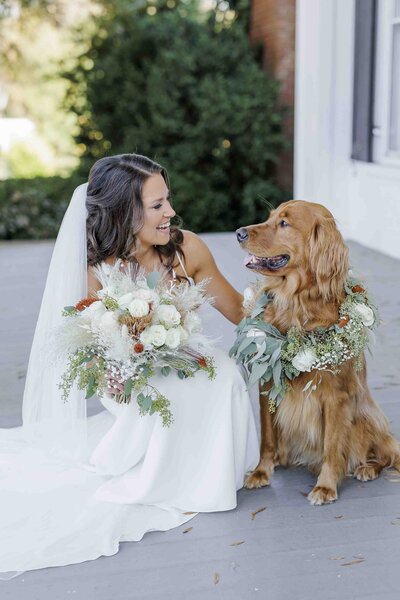 bride with flowers petting dog