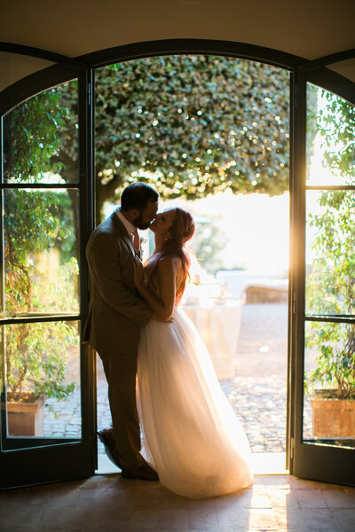 Bride and groom kiss after wedding celebration in Italy