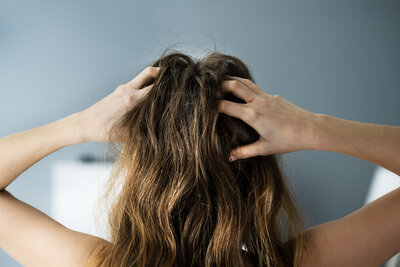 Burned out woman literally about to tear her hair out in frustration and overwhelm.